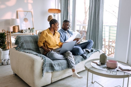 Couple talking on the couch with documents