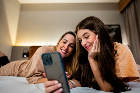 mother and teenaged daughter taking a selfie