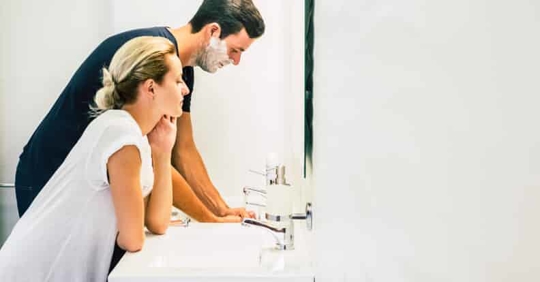 man and woman at bathroom counter